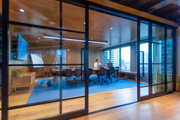 istock Business people working in a board room with a laptop and presentation. 1572946448