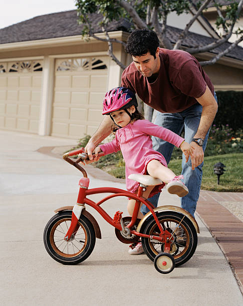 istock Father Daughter Bike Training 157294727
