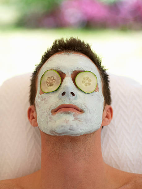 facial - facial mask spa treatment cucumber human face imagens e fotografias de stock