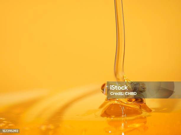 Delectable Stream Of Honey Flowing Into A Pool Of Honey Stock Photo - Download Image Now