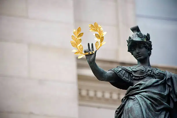 A statue with gold laurel in his hand.