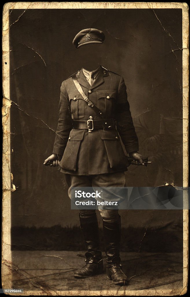 old faceless soldier pose an old faded worn and creased photograph of a soldier with face blanked out World War I Stock Photo