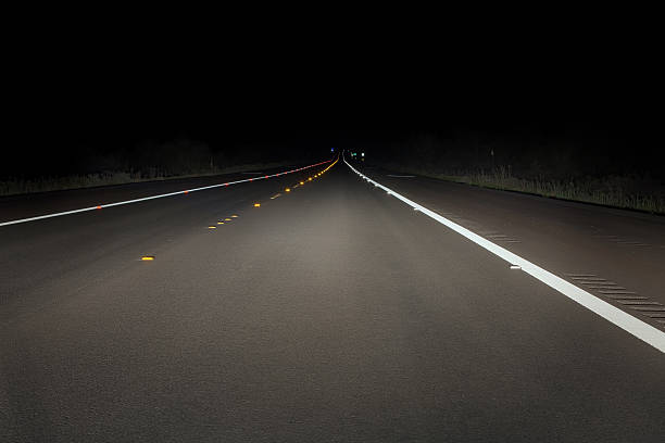 Safety concept: night drive on a fresh paved road  reflector stock pictures, royalty-free photos & images