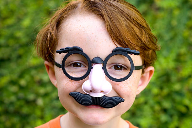 Child Redhead Boy, Disguise & Glasses Making Funny Face, Halloween Costume  groucho marx disguise stock pictures, royalty-free photos & images