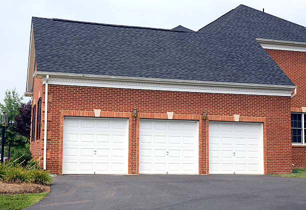 Three Car Garage  Home  Suburbia Three Car Garage on brick American luxury home vehicle door stock pictures, royalty-free photos & images