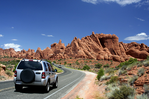 Automobile traveling through Arches National Park in Utah.