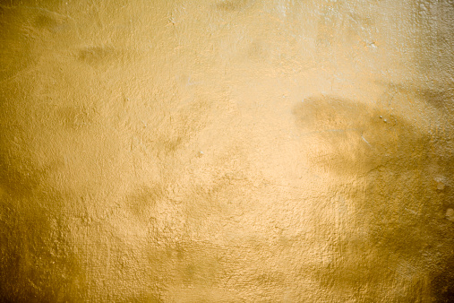 A wall painted of gold, realistic gold texture.