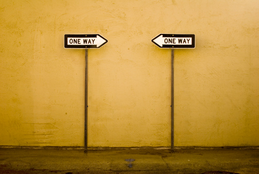 Two one-way signs pointing in opposite directions.