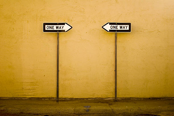 Opposite ways Two one-way signs pointing in opposite directions. one way stock pictures, royalty-free photos & images