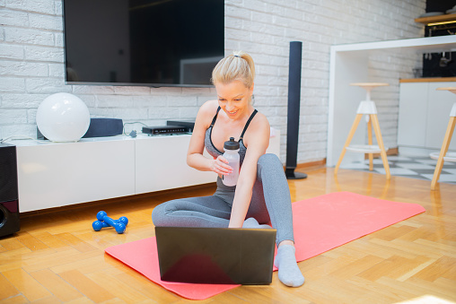 Woman doing home workout in living room