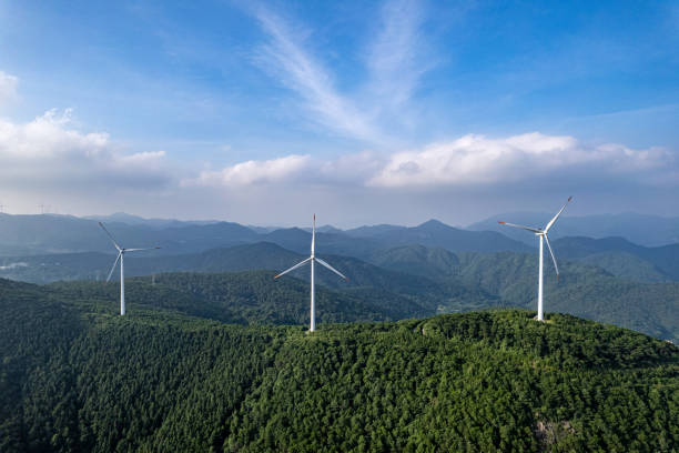 istock On a sunny day, wind turbines on forested mountains 1573026360