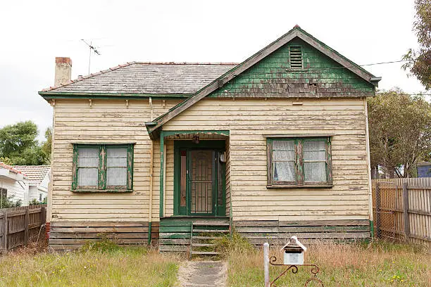 Old derelict timber home left abandoned in the suburbs
