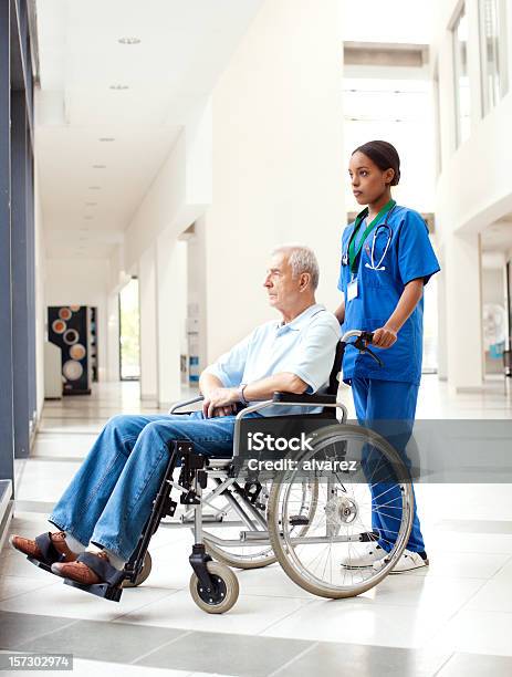 Nurse Helping A Patient In Wheelchair Stock Photo - Download Image Now - African Ethnicity, African-American Ethnicity, Healthcare Worker