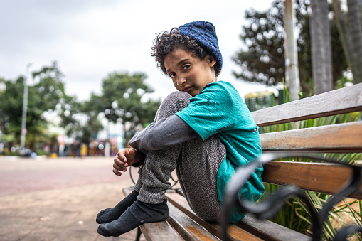 Portrait of a child homeless boy outdoors