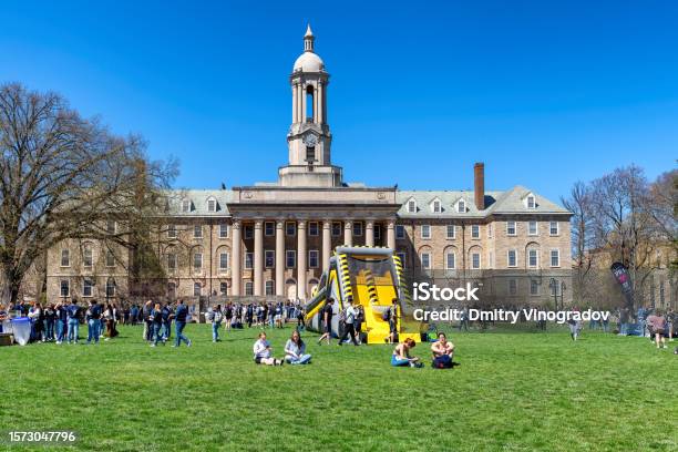 Students Near The Old Main Building On The Campus Of Penn State University In Springtime Stock Photo - Download Image Now