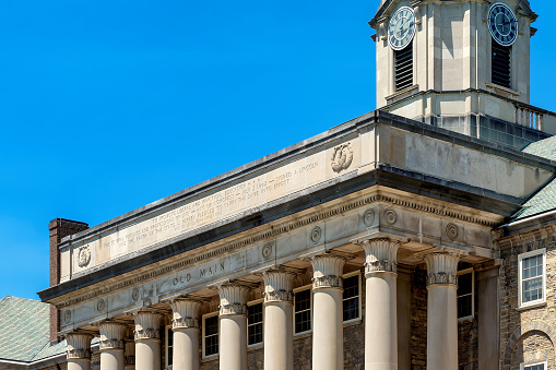 The Old Main building at sunny day on the campus of Penn State University on March 7, 2023 in State College, Pennsylvania, USA.