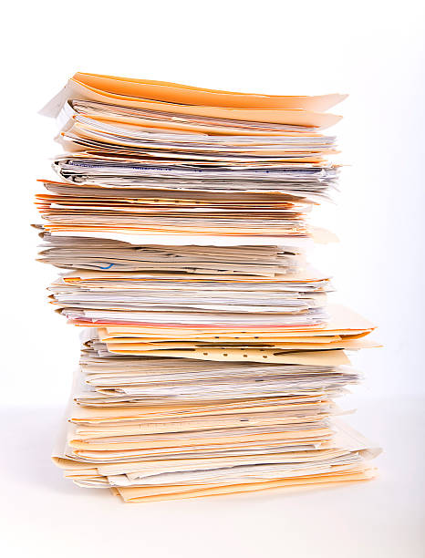 Paperwork Overload A stack of paperwork files against a white background. stacking stock pictures, royalty-free photos & images