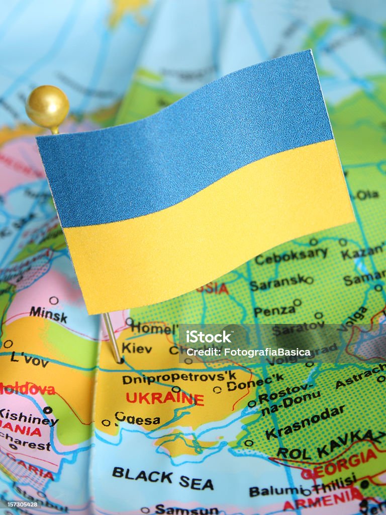 Ukraine Ukranian flag over cheap plastic map pointing Kiev. Shallow depth of field Ukraine Stock Photo