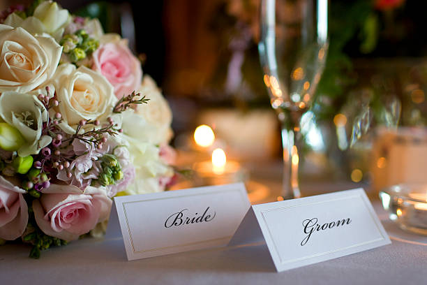 Bride and Groom Place Cards with Bouquet at Wedding Reception stock photo