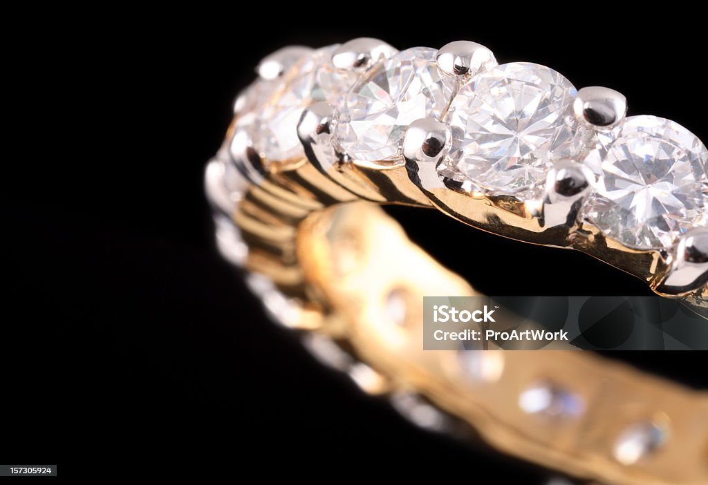 Close up view of gold ring with diamonds Macro shot of a diamond eternity/anniversary ring. Diamond - Gemstone Stock Photo