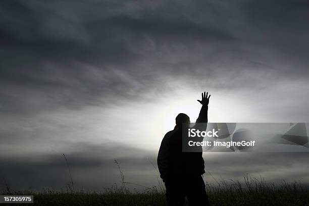 Schwarze Und Weiße Silhouette Der Mann Mit Ausgestreckten Hand In Andacht Stockfoto und mehr Bilder von Beten