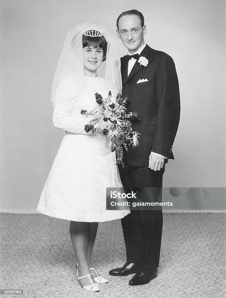 Retro portrait of a just married couple at the wedding Vintage portrait of a caucasian couple on their wedding day back in 1966. Wedding Stock Photo