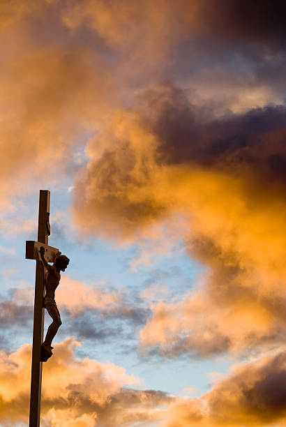 istock Crucifixion with gold clouds and Christ on the cross 157307336