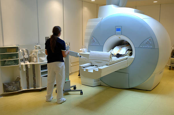 Worker using the magnetic resonance imaging scan stock photo