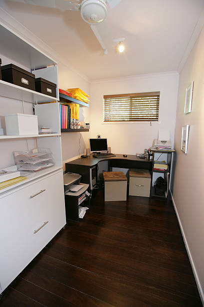 Small office with corner desk and white decor