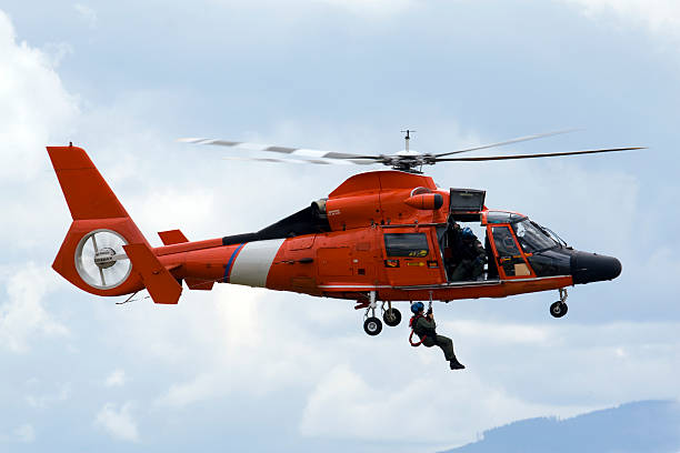 coast guard rescue hubschrauber - lowering sky stock-fotos und bilder
