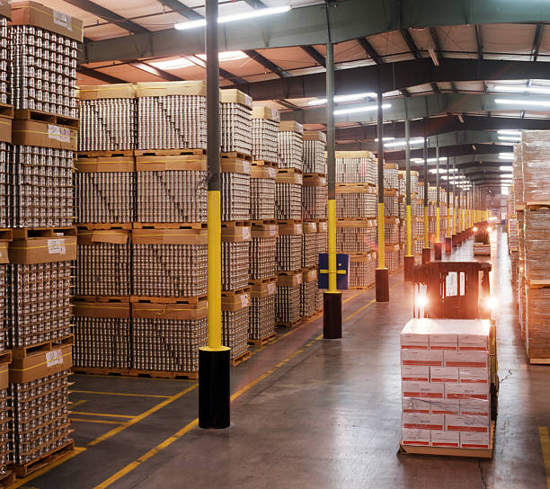 istock Forklift carrying pallet of boxes in warehouse 157307680