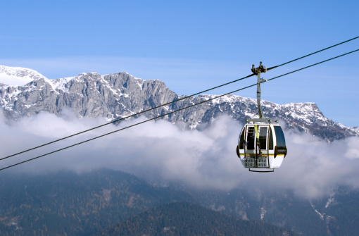 Cable-car transporting skiiers up to a mountain summit in the Alps.