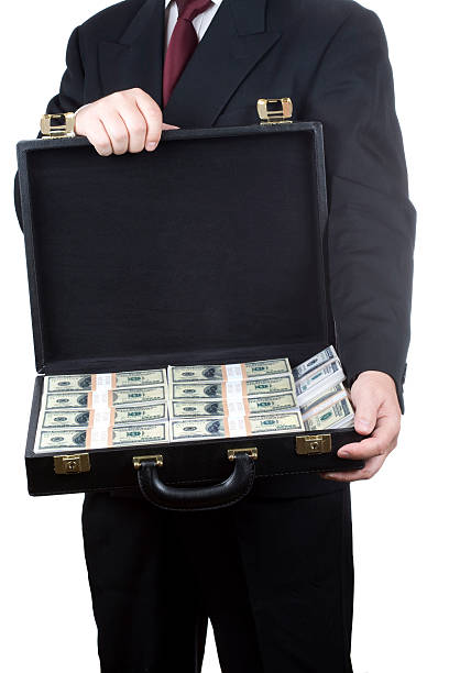 istock Man holding briefcase full of money 157307990