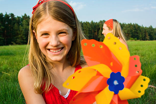 istock Litle girl with paper windmill 157308087