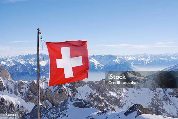 Swiss Flag Flying Over Snowy Mountains Stock Photo - Download Image Now - Swiss Flag, Switzerland, Flag