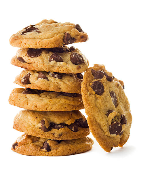 Homemade Chocolate Chip Cookies Stacked Tower Isolated on White Background Fresh, homemade chocolate chip cookies stacked in vertical tower of six morsels. One piece leans against the pile. The baked, gourmet dark chocolate treat is a favorite dessert or after-school snack with milk. The sweet food indulgence contributes to overeating fats and sugars, an unhealthy diet. Isolated on white background. cookie stock pictures, royalty-free photos & images