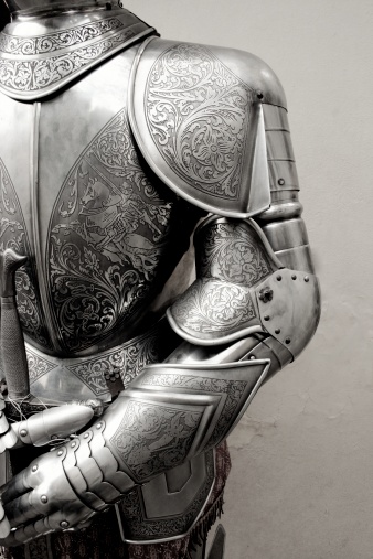 Protective gauntlet from metal plates as fully fingered glove, part of a historical knight armor replica at a medieval festival, copy space, selected focus, narrow depth of field