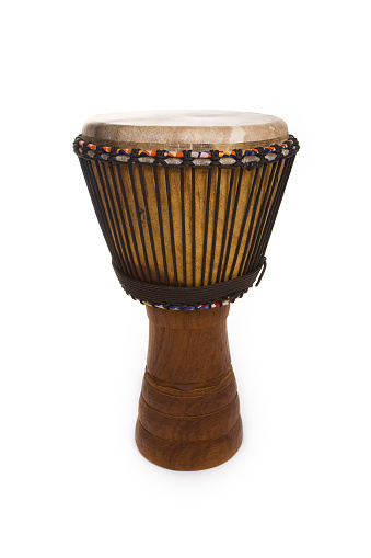 An African made wooden Djembe drum isolated on a white background.