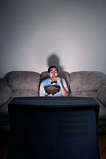 istock Nerdy Guy Watching A Movie At Home 157308653
