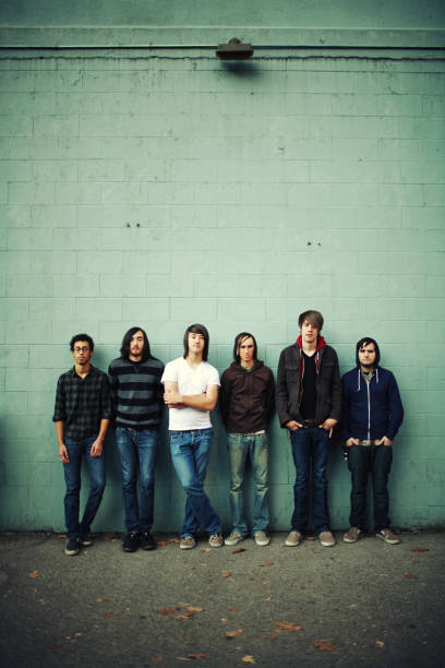 istock Group of Young Men Standing on a Green Brick Wall 157308923