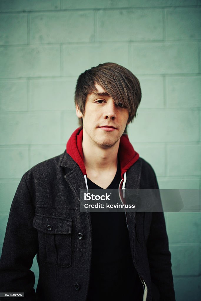 Tall Young Man in Jacket  Against Green Brick Wall  Men Stock Photo