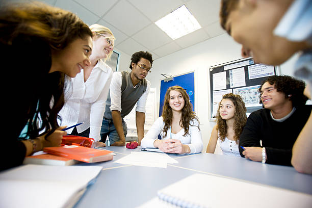further education: diverse teenagers working on a class project stock photo