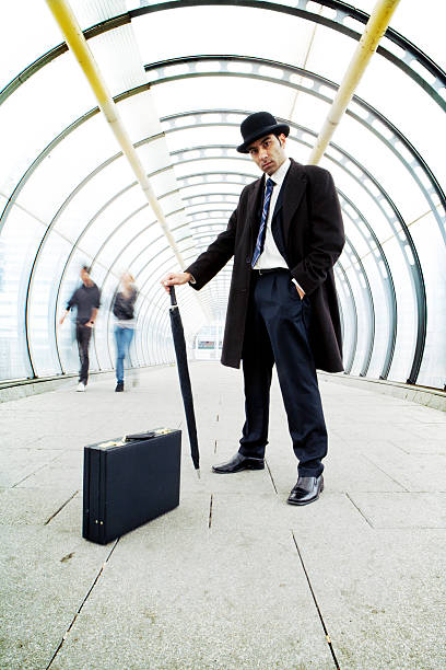 istock Male boss holding an umbrella with a suitcase in corridor 157309689