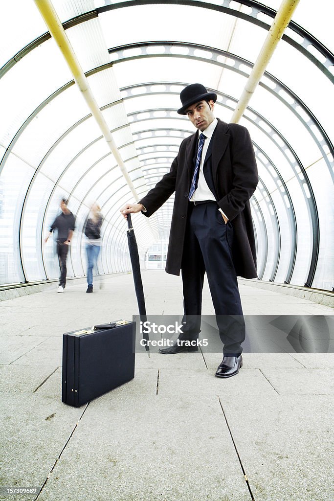 Male boss holding an umbrella with a suitcase in corridor  40-44 Years Stock Photo