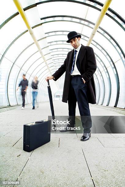 Male Boss Holding An Umbrella With A Suitcase In Corridor Stock Photo - Download Image Now
