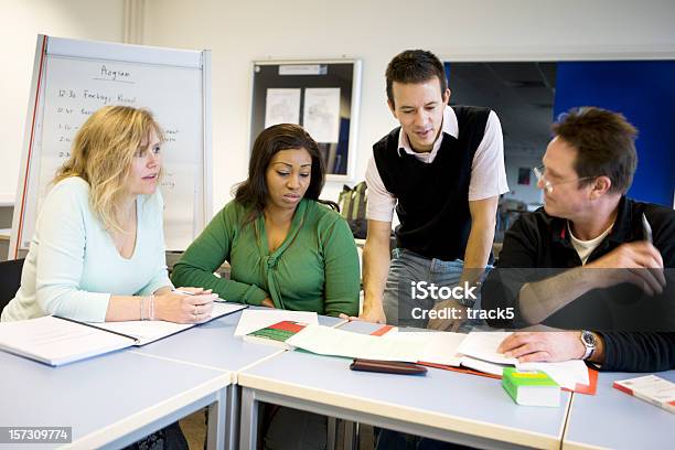 Adult Education Mature Students Debating A Project With Their Teacher Stock Photo - Download Image Now