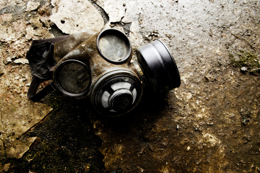 Retro gas mask laying on grungy floor. 