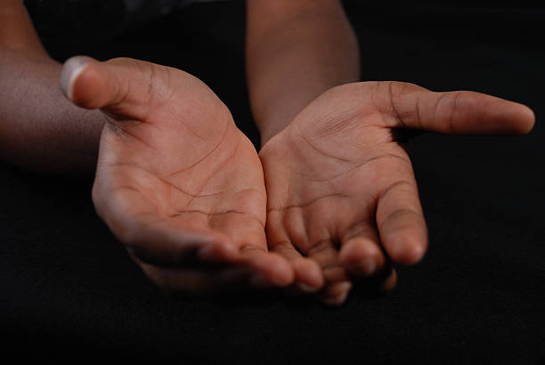 Outstretched hands of a Young Black Man stock photo