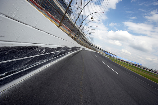 Checkered racing finish flag and asphalt road outdoors