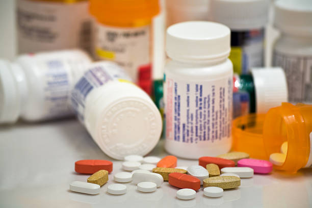 medicine pills and bottles The overwhelming pills and bottles that can be part of today's lifestyle. Emphasis on the pills in the foreground. pill prescription capsule prescription medicine stock pictures, royalty-free photos & images